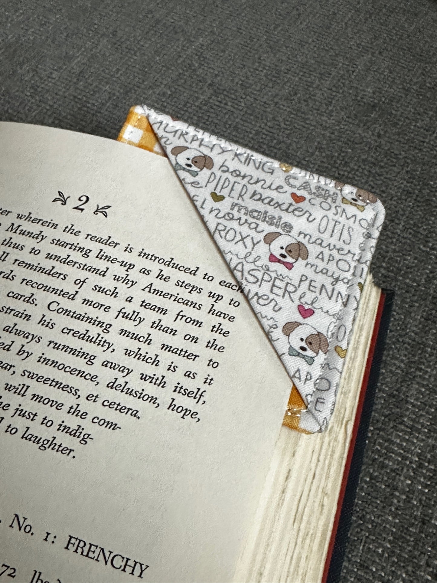 Book with a bookmark featuring cartoon characters on a textured surface