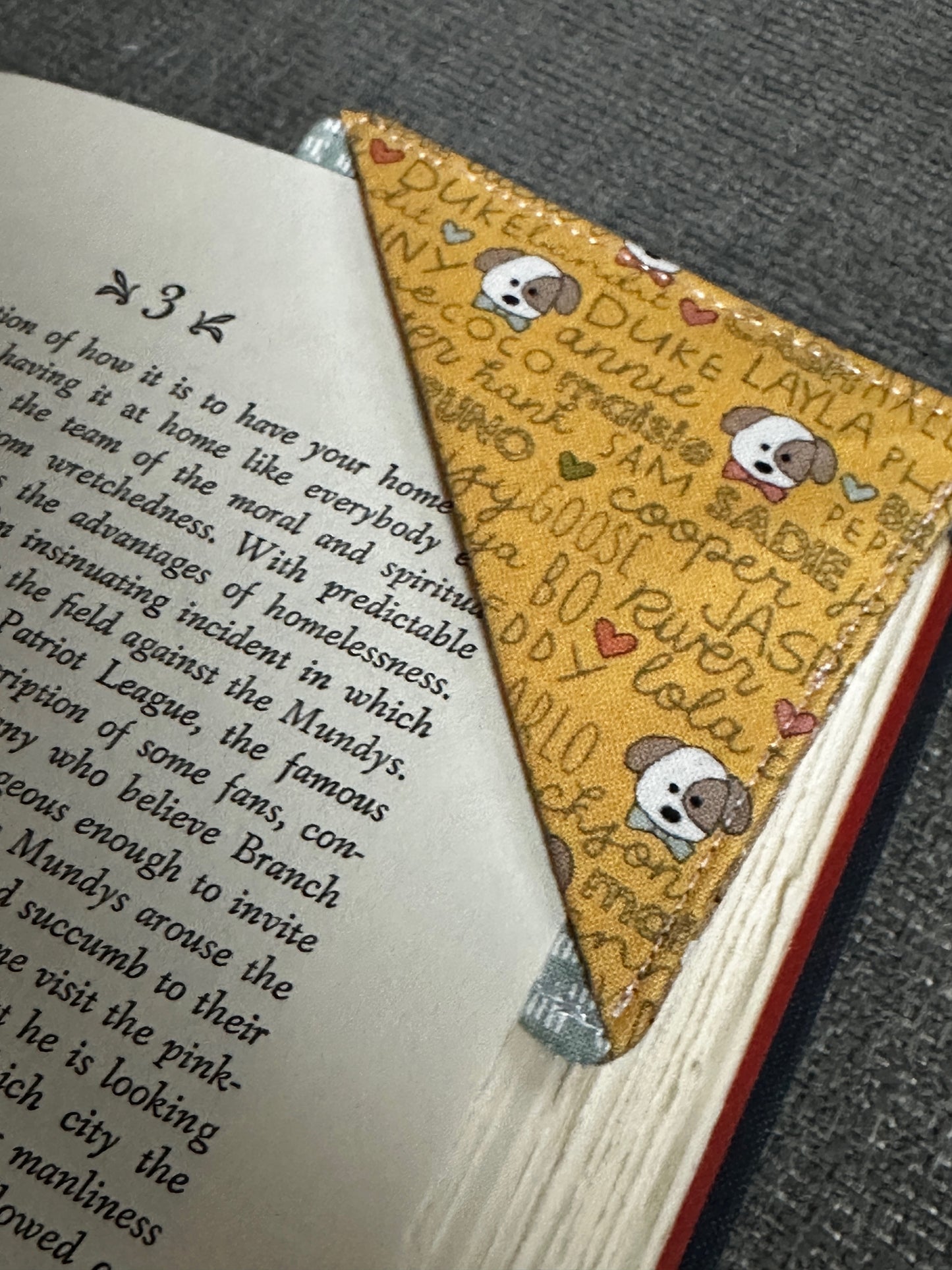 Book with a decorative corner bookmark featuring cartoon characters and text.