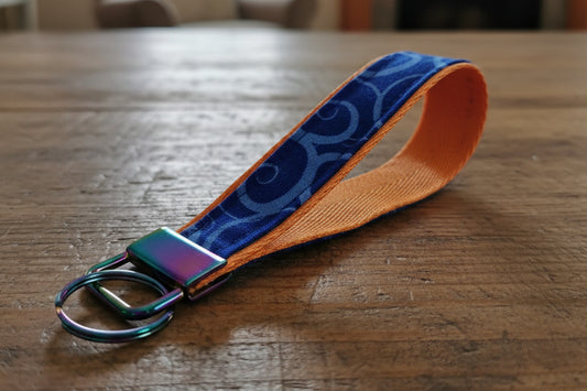 Keychain with blue patterned strap and rainbow metal clasp