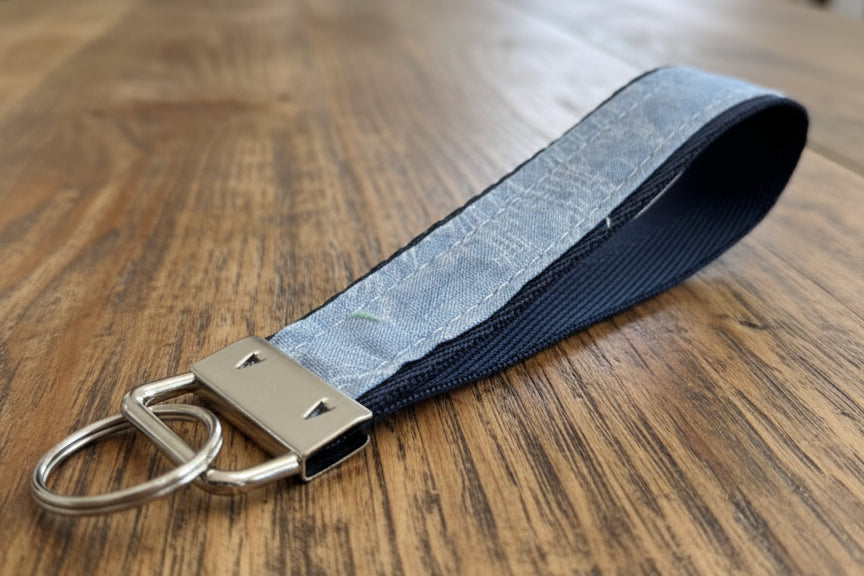 Keychain with blue fabric strap and silver hardware