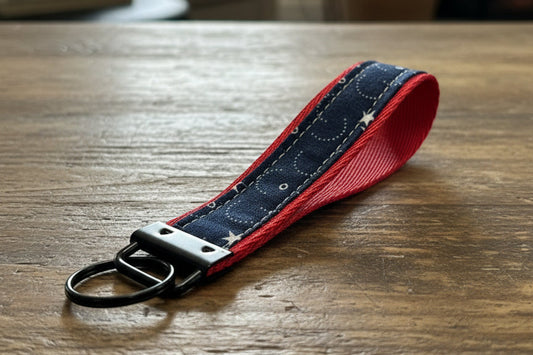 Keychain with red border and star pattern with black hardware