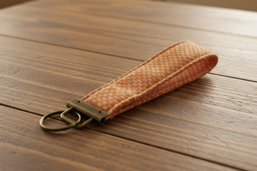 Orange fabric keychain with antique brass hardware