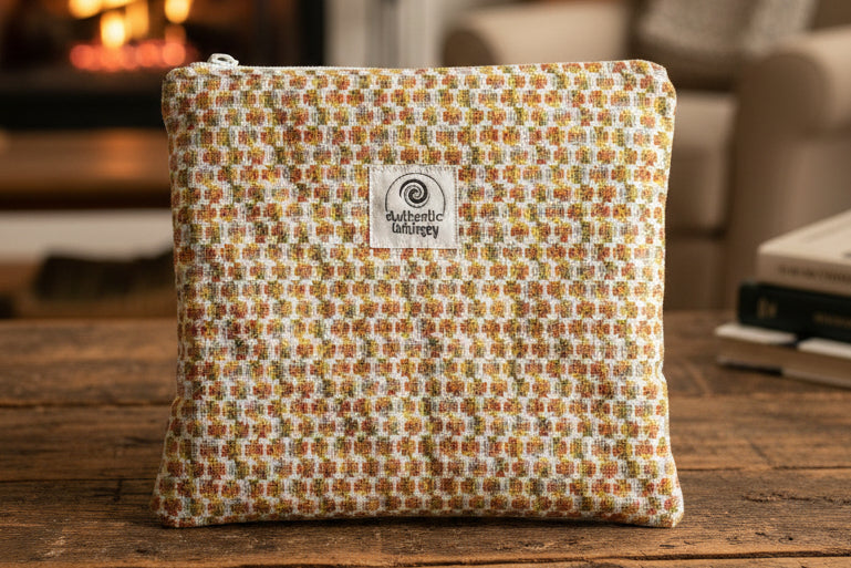 Clover-patterned pouch with a brand label on a gray background