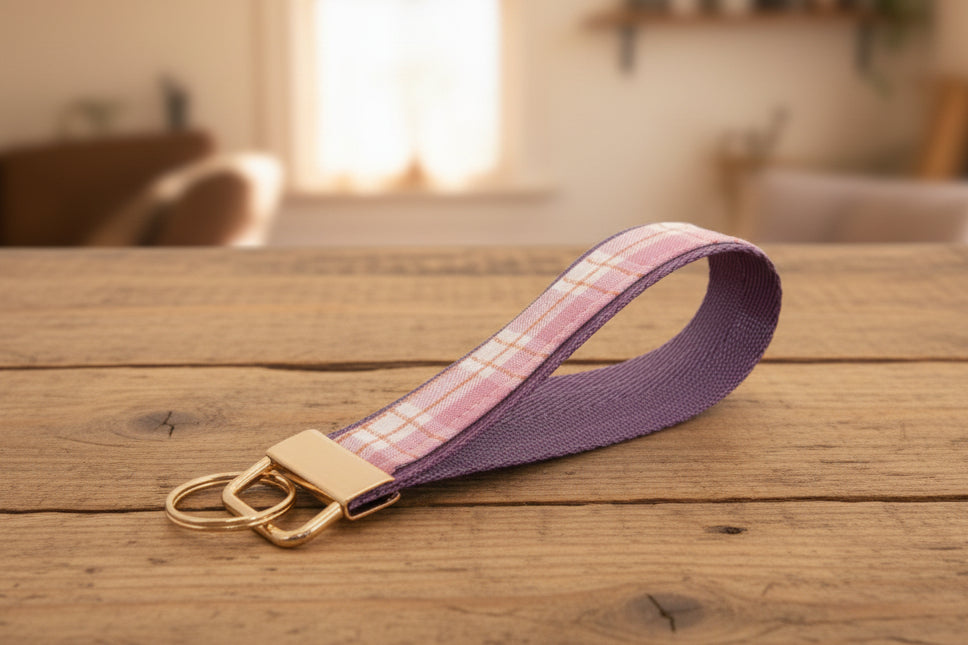 Keychain with pink and purple plaid strap and gold hardware