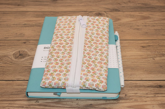 Teal notebook with multi-colored clover zipper pen pouch
