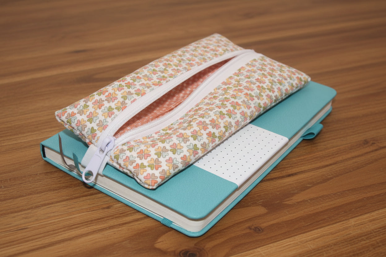 Teal notebook with multi-colored clover zipper pen pouch