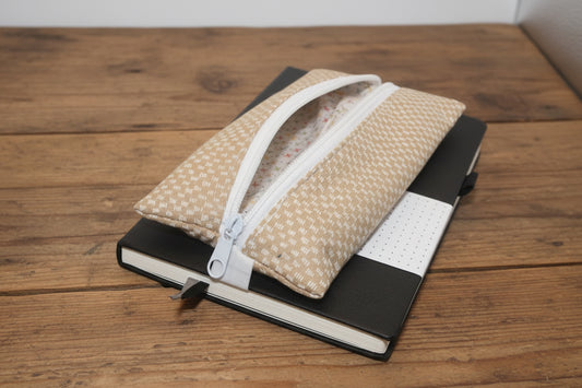 Black notebook with beige zipper pencil bag