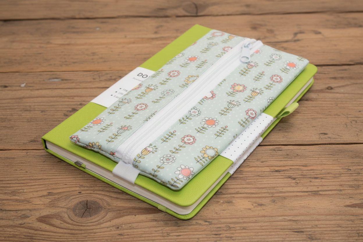 Green notebook with blue floral pen case