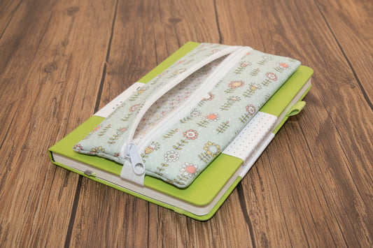 Green notebook with blue pen case