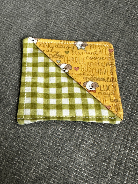 Fabric square with yellow and checkered green sides on a gray textured background