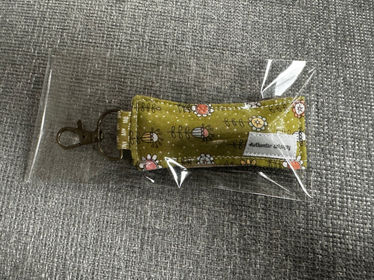 Small fabric pouch with floral design on a gray surface