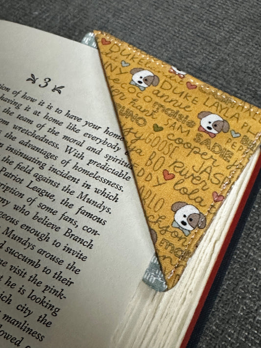 Book with a decorative corner bookmark featuring cartoon characters and text.