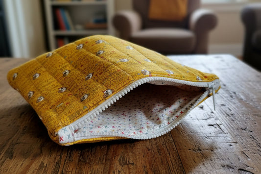 Yellow quilted pouch with dog pattern