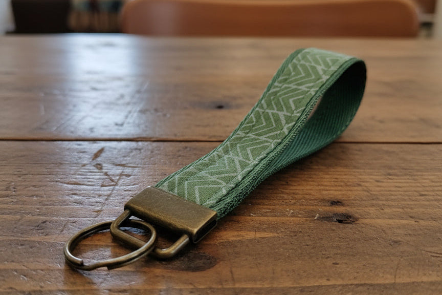 Green fabric keychain with brass hardware