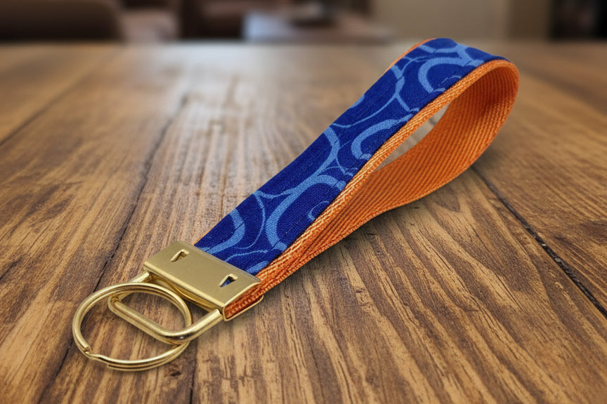 Keychain with blue patterned strap and gold clasp 