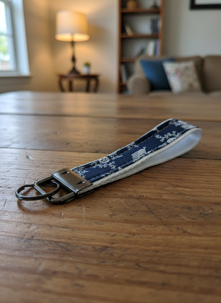 Keychain with blue patterned strap on a gray background