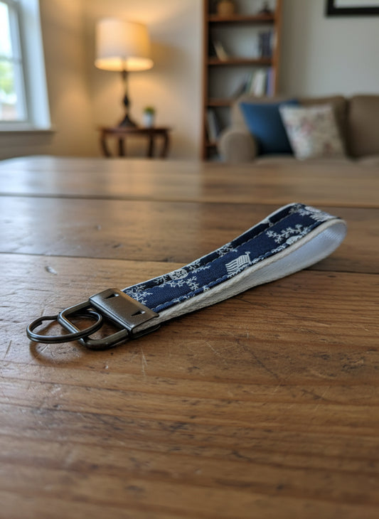 Keychain with blue patterned strap on a gray background