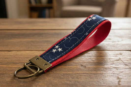 Keychain with star pattern on a red strap with antique brass hardware