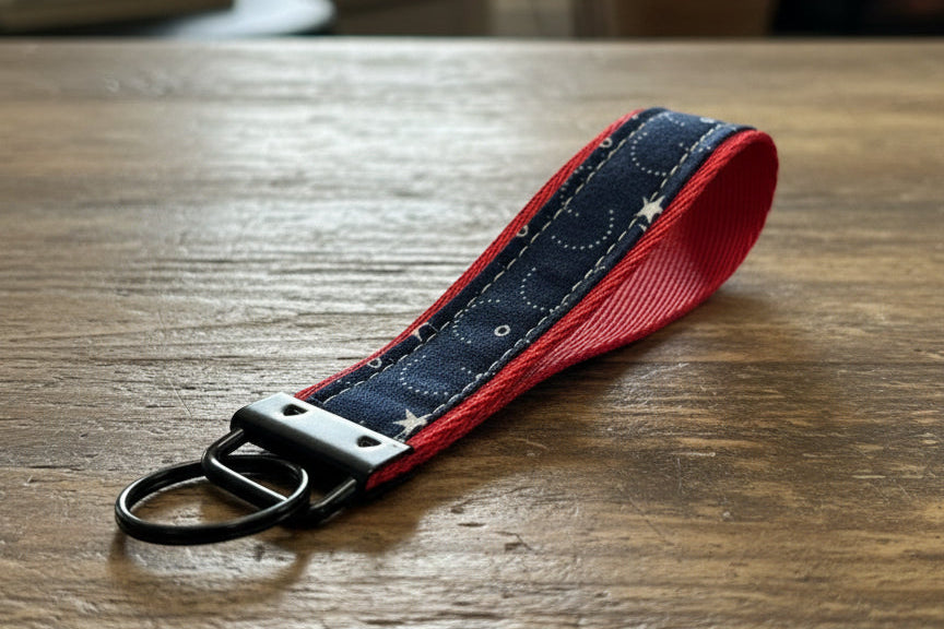 Keychain with red border and star pattern with black hardware