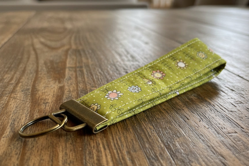 Green fabric keychain with floral patterns