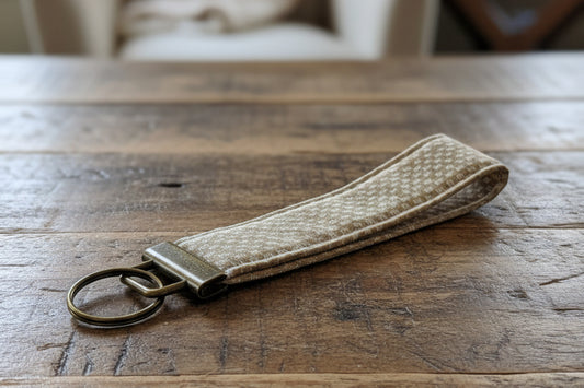 Beige patterned keychain with antique brass hardware