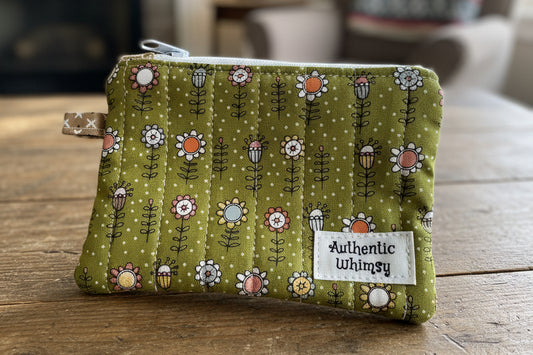 Small pouch with floral pattern and 'Authentic Whimsy' label 